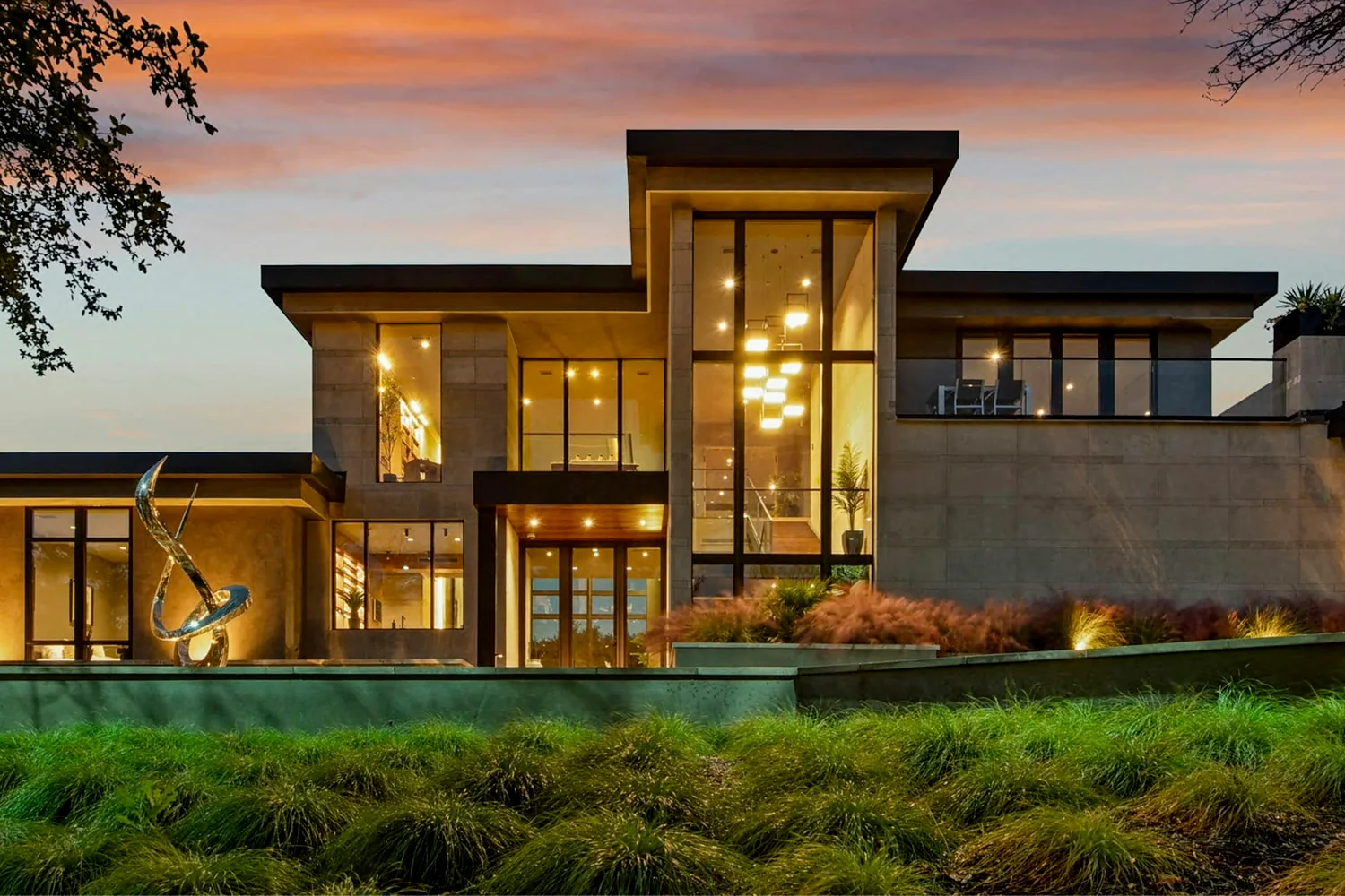 Contemporary residence at dusk with warmly lit windows